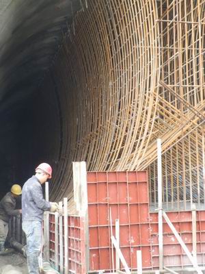 工人正在焊接小关2号隧道中导洞的中隔墙钢筋